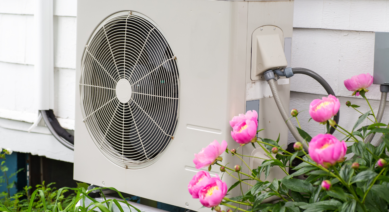 Modern UK home with a heat pump installed outside, illustrating energy-efficient heating and insulation improvements.
